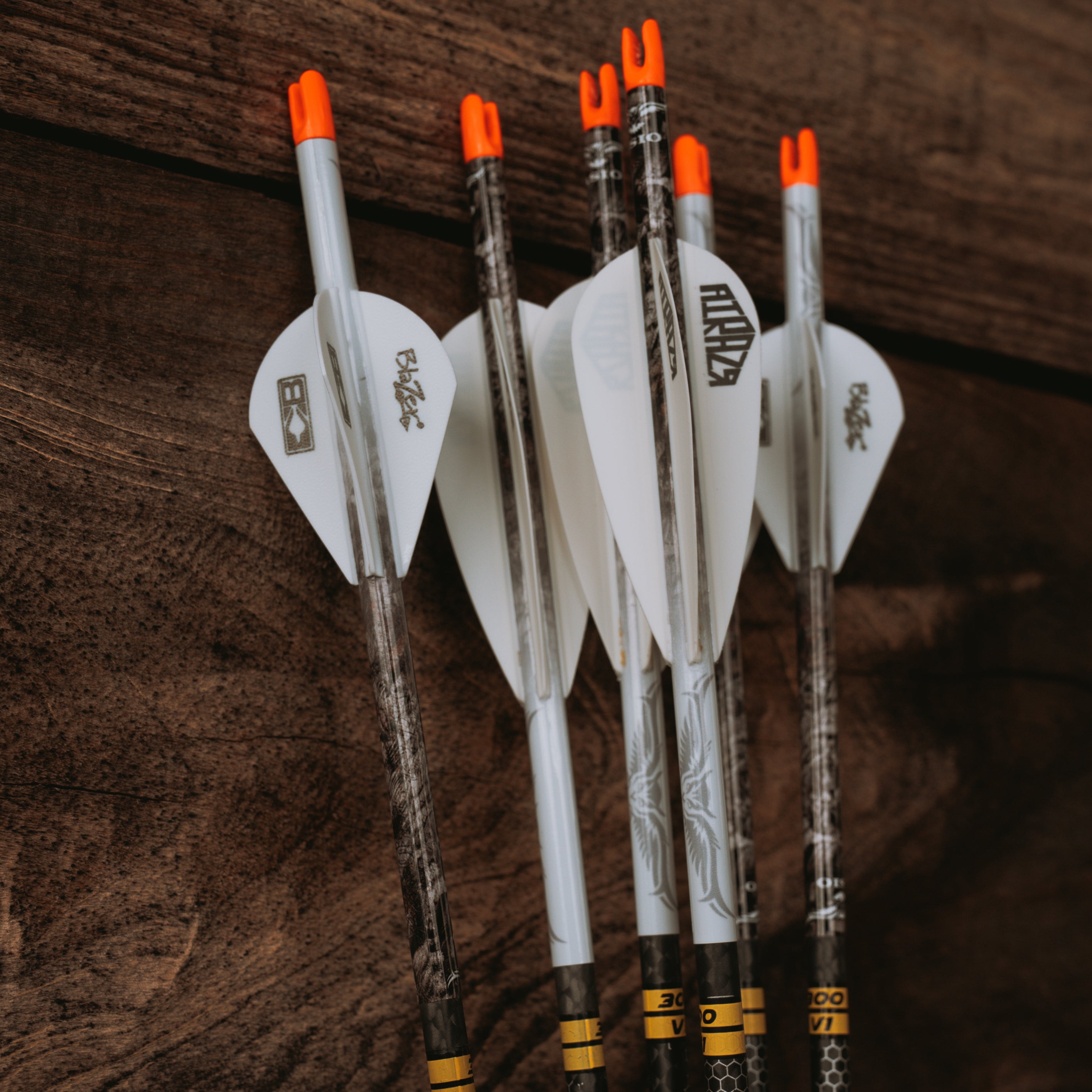 Archery Arrow Wraps with unique camo pattern displayed with a wood background