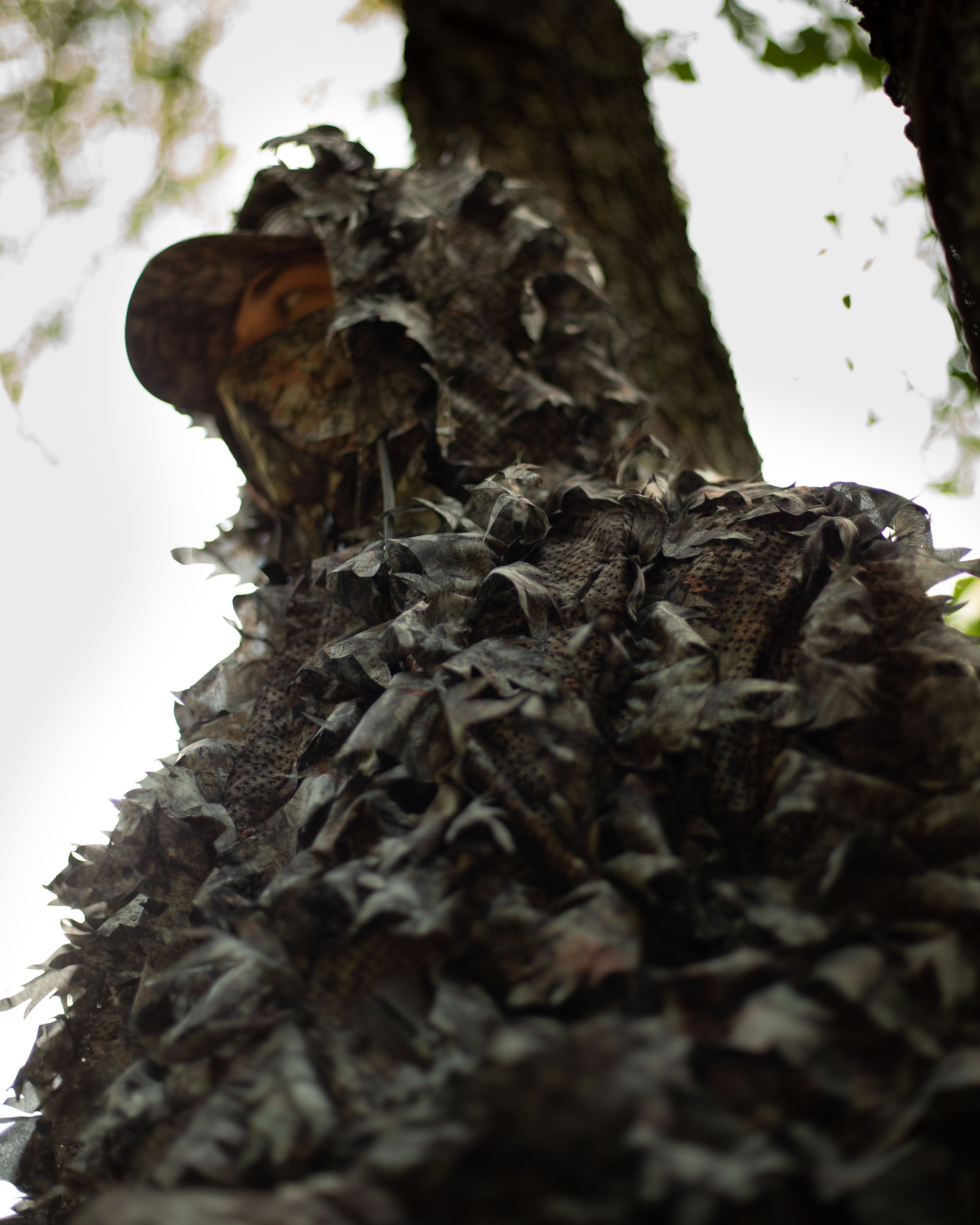 Close-up view of ASIO Gear Leafy Jacket in Raptor camo showing 3D leaf texture and concealment pattern for treestand hunters.
