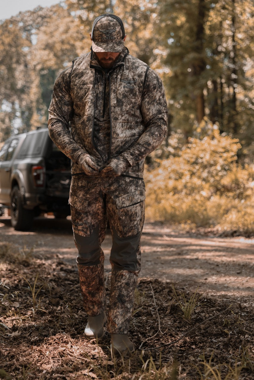 ASIO Gear Midweight Puffy Vest in RAPX CAMO®, built for ground-based bowhunters who demand warmth, stealth, and high-mobility concealment.