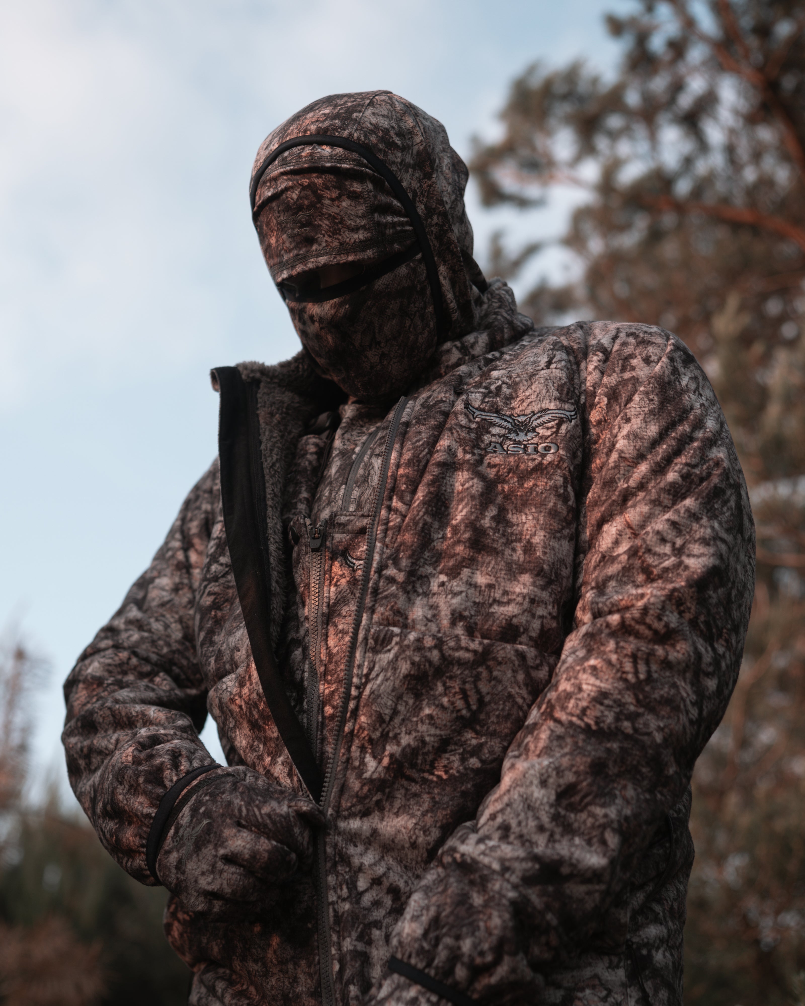 hunter zipping up asio gear raptor camo mid season windproof bowhunting jacket for hunt