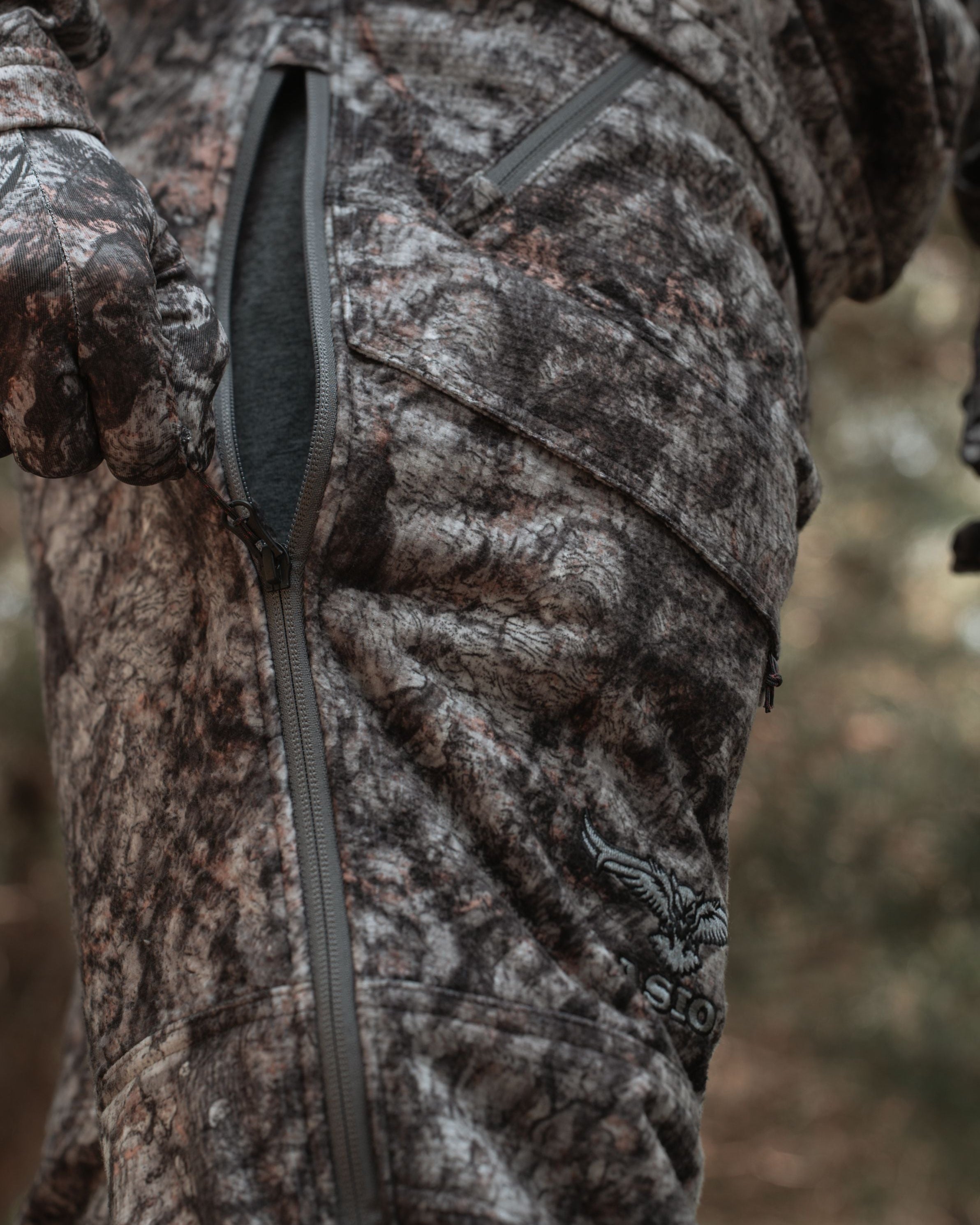 Detail view of thigh full two way zipper vent on ASIO Gear Midweight Sherpa Pant in Raptor camouflage.