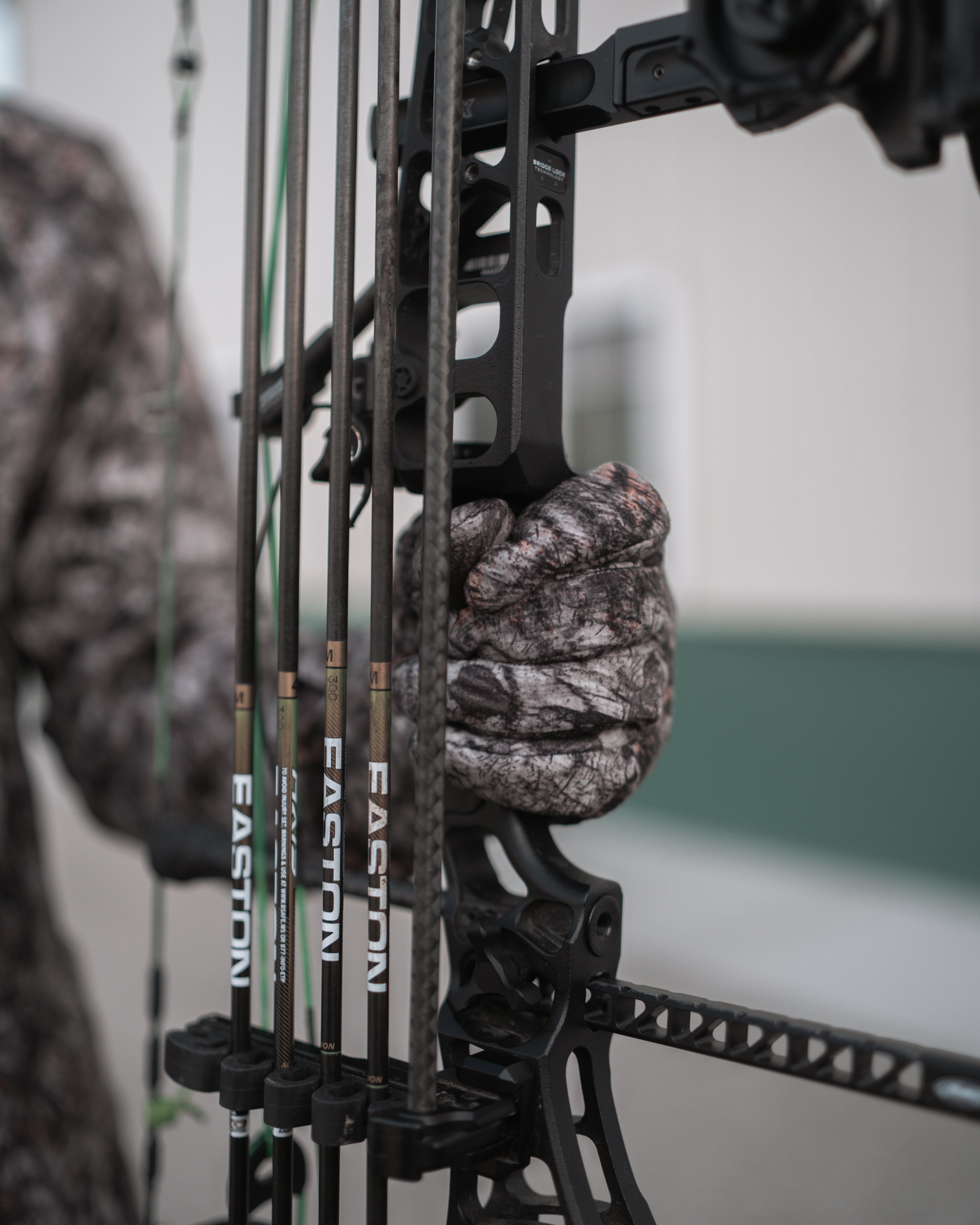 bowhunter gripping bow with midweight sherpa lined windproof glove