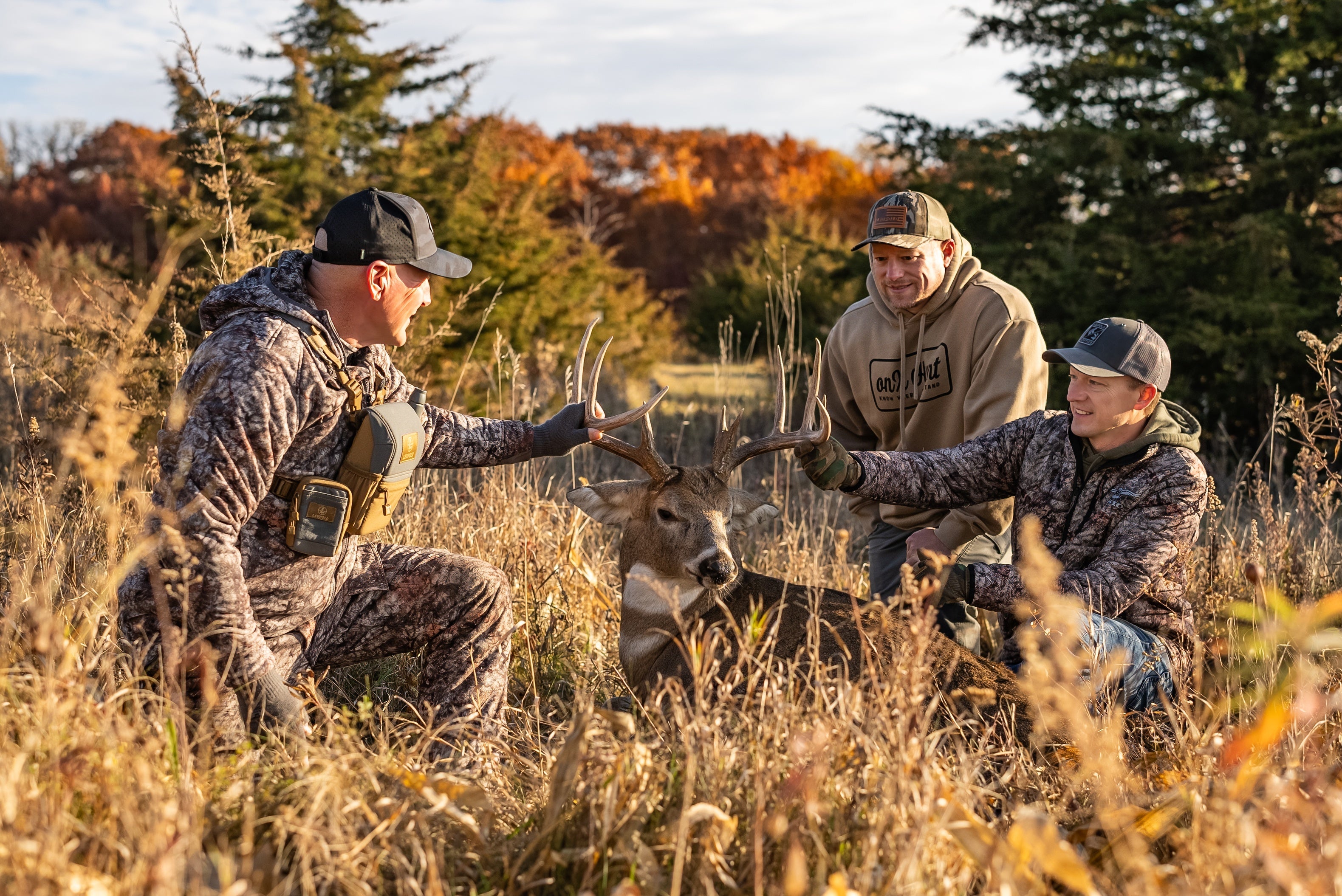 asio gear bowhunters celebrating after a successful hunt wearing some of ASIO Gear's best selling gear