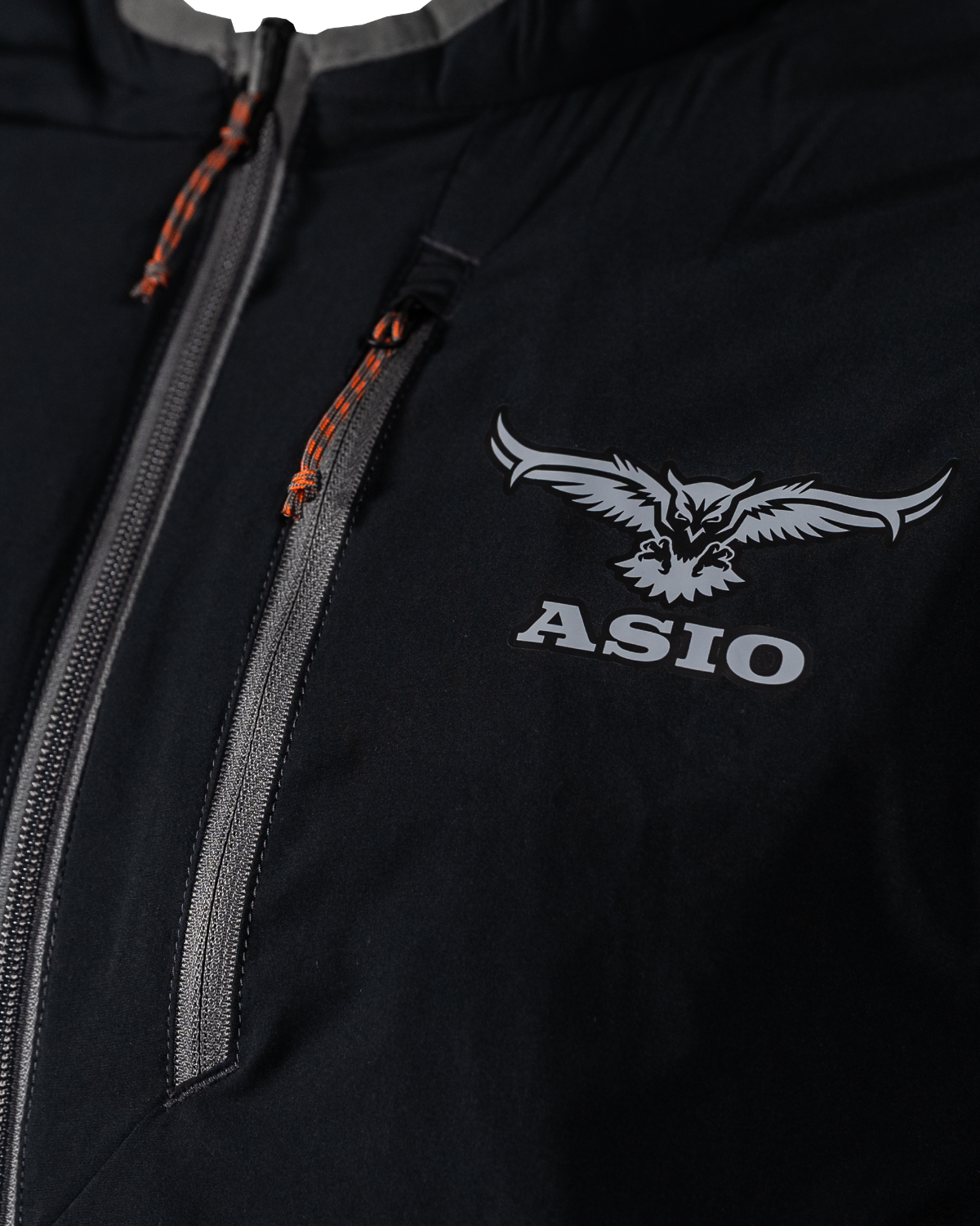 Chest detail of the black reversible side showing the ASIO logo and zipper
