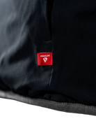 Hem detail of the black reversible side with the PrimaLoft insulation tag