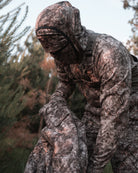 hunter grabbing camo bowhunting jacket 